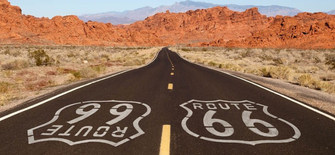Route 66 shield and highway stretching into the horizon